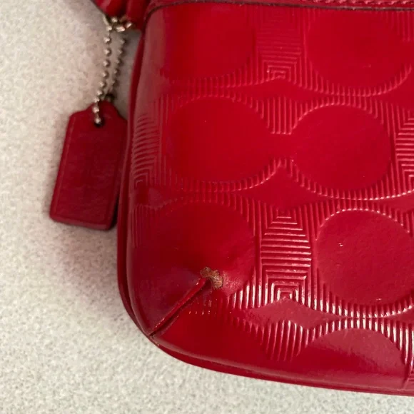 Coach Glossy Embossed Signature Wristlet
Cranberry Patent Leather Red - Picture 10 of 13